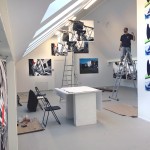 Graduate student and graphic designer Vytis Snarskis installing 112x152cm photographic works at Meno Parkas Galerija